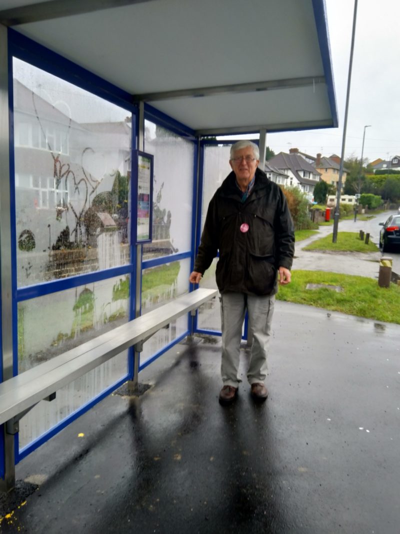 Councillor Michael Bell in the new bus shelter